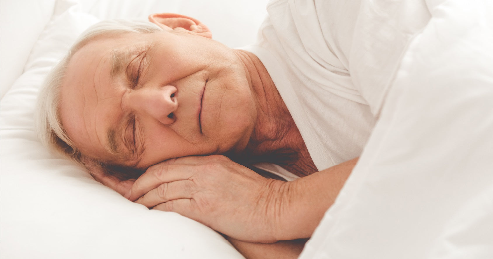 Elderly man sleeping in bed