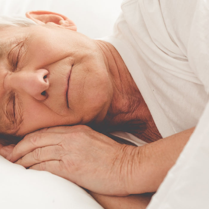 Elderly man sleeping in bed