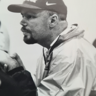 A black and white image of Tony Howe coaching