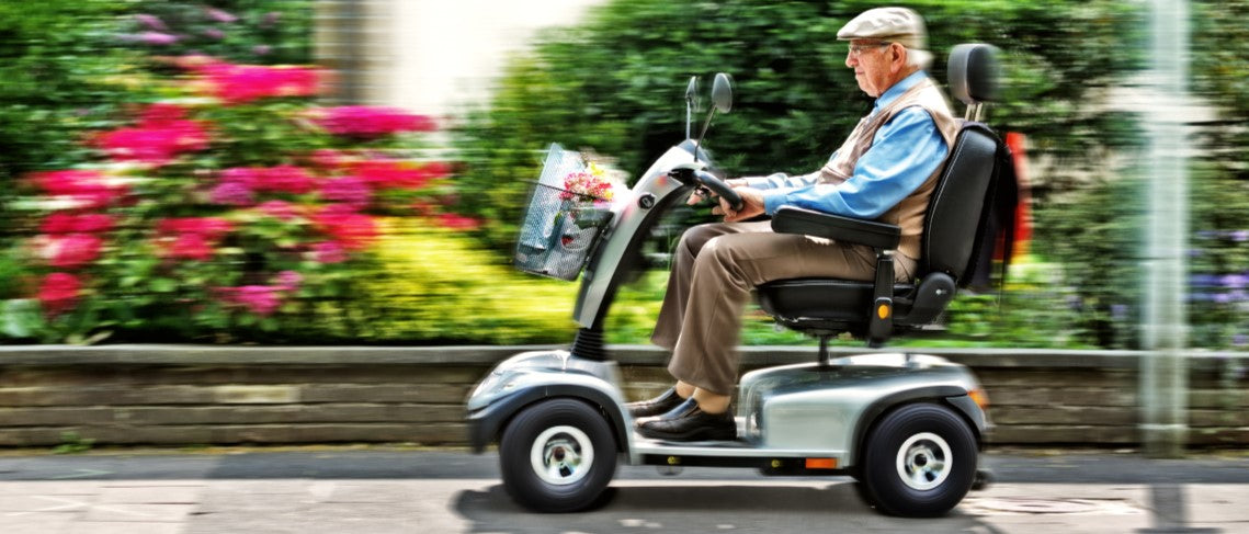 Senior man driving mobility scooter