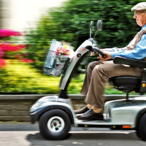 Senior man driving mobility scooter